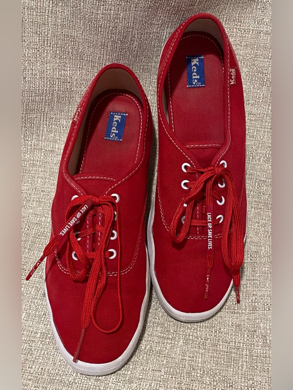 Keds Red Canvas Low-Top Sneakers with “Nike Lace Up. Save Lives.” laces